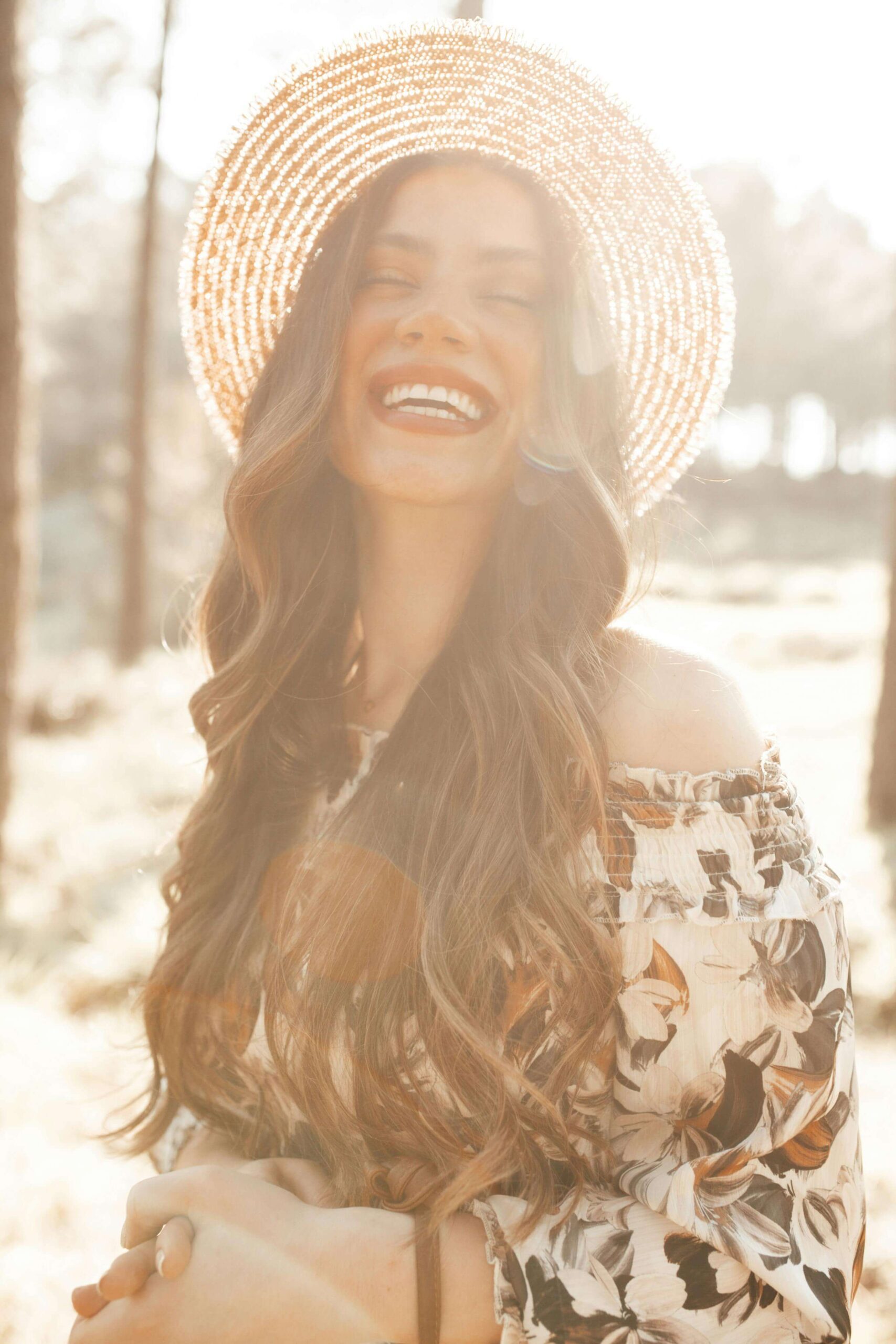 A woman in a wide-brimmed straw hat laughs joyfully. What if releasing unresolved trauma could transform how you experience joy and connection in your relationships? Relational trauma therapy in Palm Beach, FL, can help you get there.