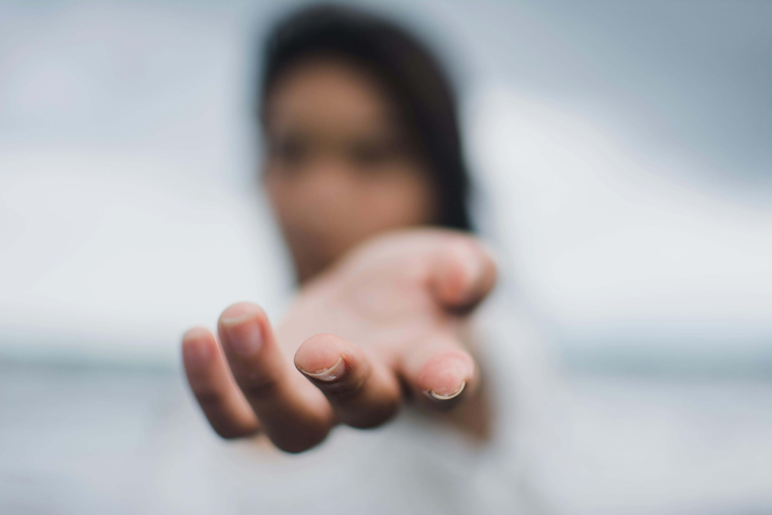 A blurred woman extends her open hand, a gesture of reaching out. Are one-sided relationships leaving you constantly reaching out with nothing coming back in return? Relational trauma therapy in Palm Beach, FL, offers support to help you find the balance you deserve.