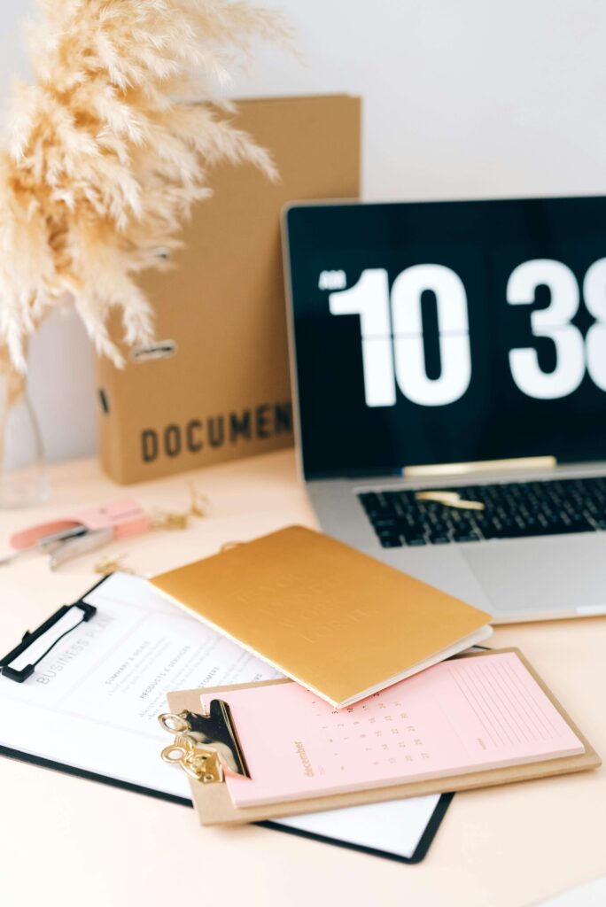 A neatly arranged desk displays clipboards, a gold notebook, and documents. Is your need for a perfectly organized life rooted in trauma responses? Relational trauma therapy in Palm Beach, FL, can help you find balance beyond the need for control.