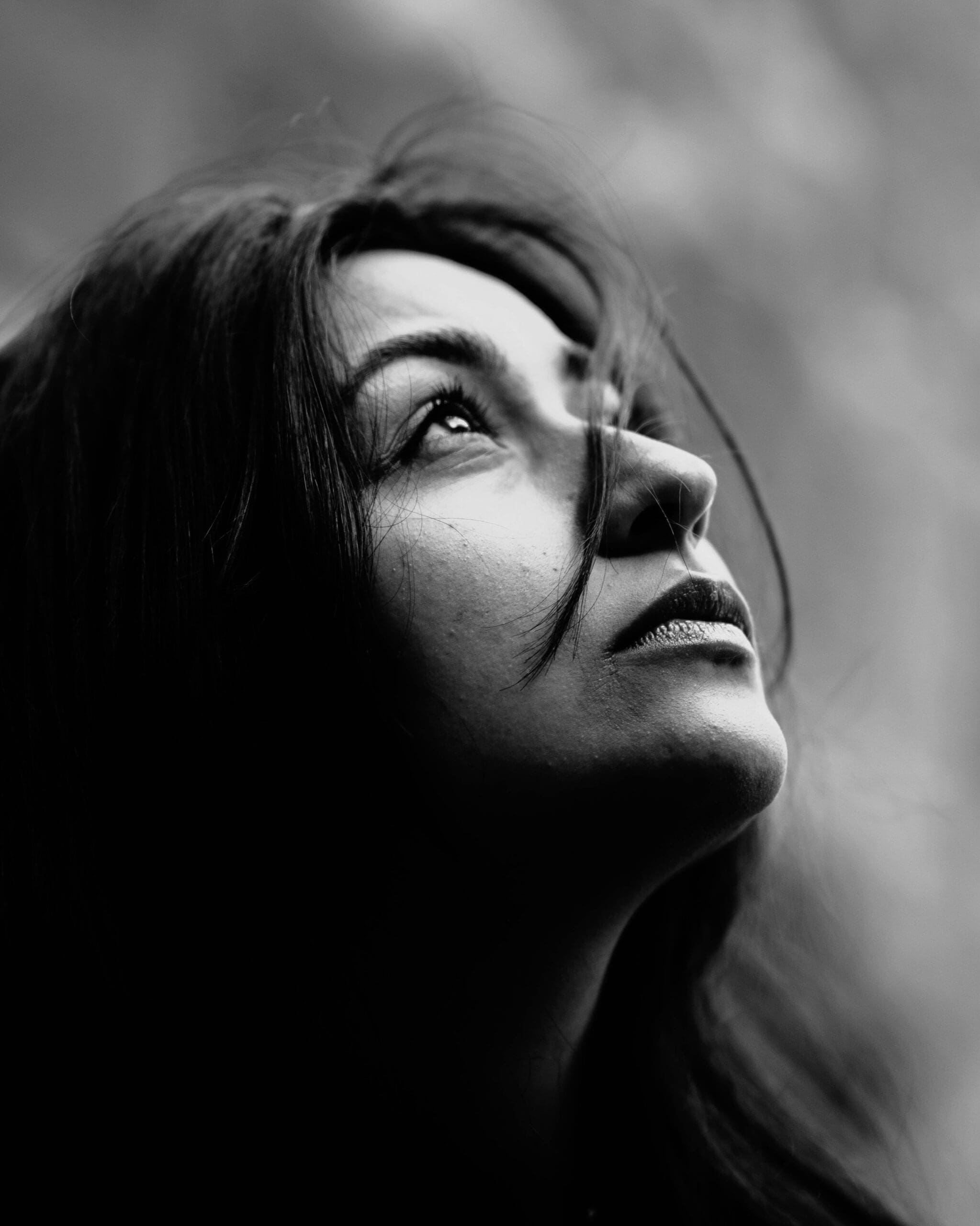 Gazing upward | betrayal trauma palm beach | relational trauma therapist| online trauma therapy | Palm Beach, Florida | Delray Beach | Westlake | The Palm Beaches | The Breakers A black and white close-up of a woman gazing upward. When betrayal dismantles everything you thought you knew, where do you even begin to find solid ground again? Relational trauma therapy in Palm Beach, FL, offers a path through the confusion and heartbreak toward healing.