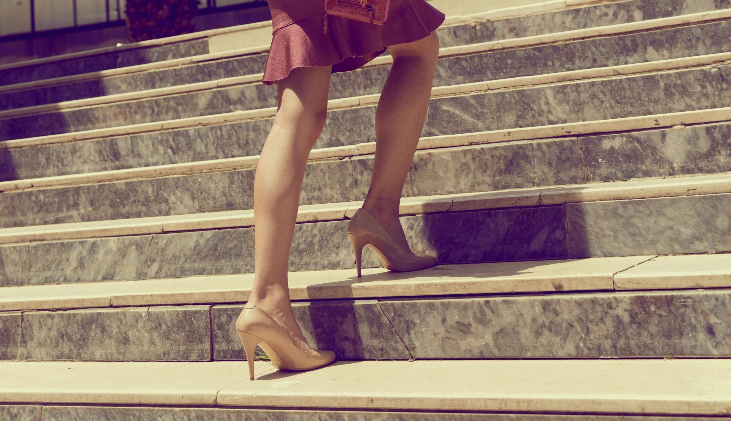 A woman in heels climbs wide marble steps. Are you ready to stop waiting for communication breakthroughs and finally take the next step toward healing? Relational trauma therapy in Palm Beach, FL, can help you move beyond the patterns keeping you stuck.