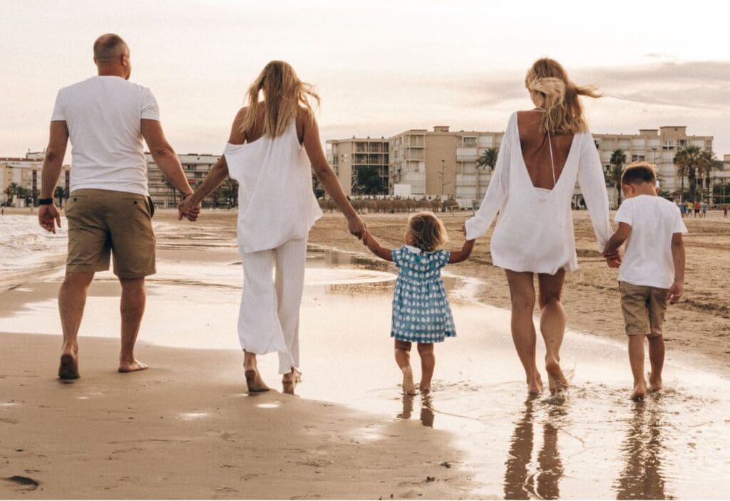 Family | how to enjoy a family vacation palm beach | complex ptsd online therapist palm beach, fl | relational trauma therapy | Palm Beach, Florida | Wellington | Boynton Beach | The Island | The Colony Hotel A family of five walks hand in hand on a beach. Do family vacations leave you more depleted than restored, even when everything looks picture-perfect? Relational trauma therapy in Palm Beach, FL, can help you stop managing the trip and start living it.