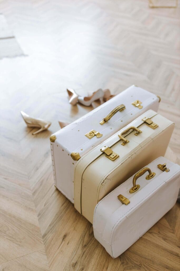 Suitcases | how to enjoy a family vacation palm beach | relational trauma therapist palm beach, fl | complex ptsd therapist | Palm Beach, Florida | Delray Beach | Westlake | The Palm Beaches | The Breakers Three stacked vintage white suitcases. Are you packing for another family vacation while anticipating the exhaustion of carrying everyone's experience? A relational trauma therapist in Palm Beach, FL, can help you put some of that weight down.