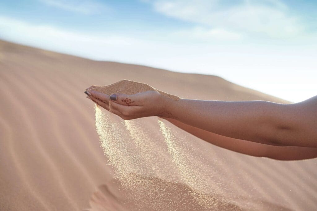 Holding sand | summer pressure and high achieving women palm beach | trauma therapy for high achievers plam beach | complex relational trauma | Palm Beach, Florida | Jupiter | Palm Beach Gardens | Wall Street South | Whitehall A tattooed hand holds a fistful of sand. Is summer pressure making you feel like you are trying to hold everything together while it keeps slipping through your hands? A relational trauma therapist in Palm Beach, FL, can help you release that grip.