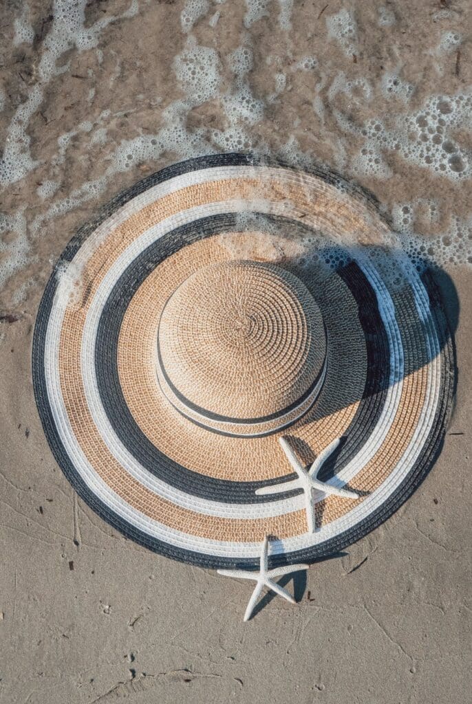 Beach hat | summer pressure palm beach | relational trauma therapist palm beach, fl | complex ptsd therapist | Palm Beach, Florida | Delray Beach | Westlake | The Palm Beaches | The Breakers A wide-brimmed straw hat rests on wet sand beside a white starfish. Are you wondering why summer still doesn't bring the happiness or relief you've been quietly hoping it would? Relational trauma therapy in Palm Beach, FL, can help you find out why.