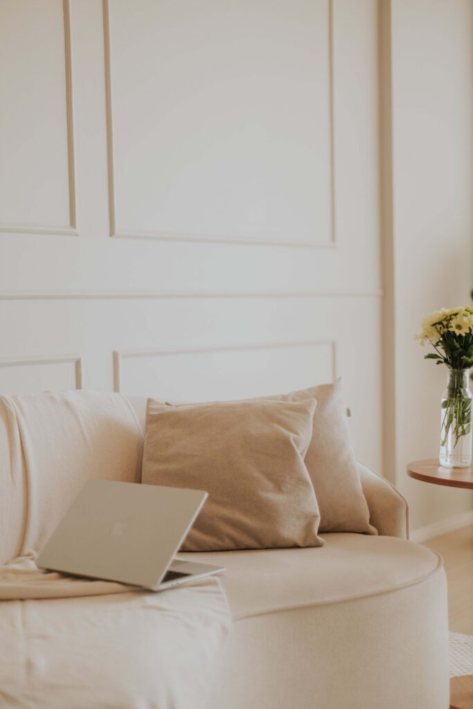 Neutral couch | how to find an online therapist palm beach | relational trauma therapist palm beach, fl | complex ptsd therapist | Palm Beach, Florida | Delray Beach | Westlake | The Palm Beaches | The Breakers A laptop rests open on a soft, neutral-toned couch beside decorative pillows. How do you know if online therapy sessions feel right for you? Online relational trauma therapy in Palm Beach, FL creates a space that feels safe and comfortable.