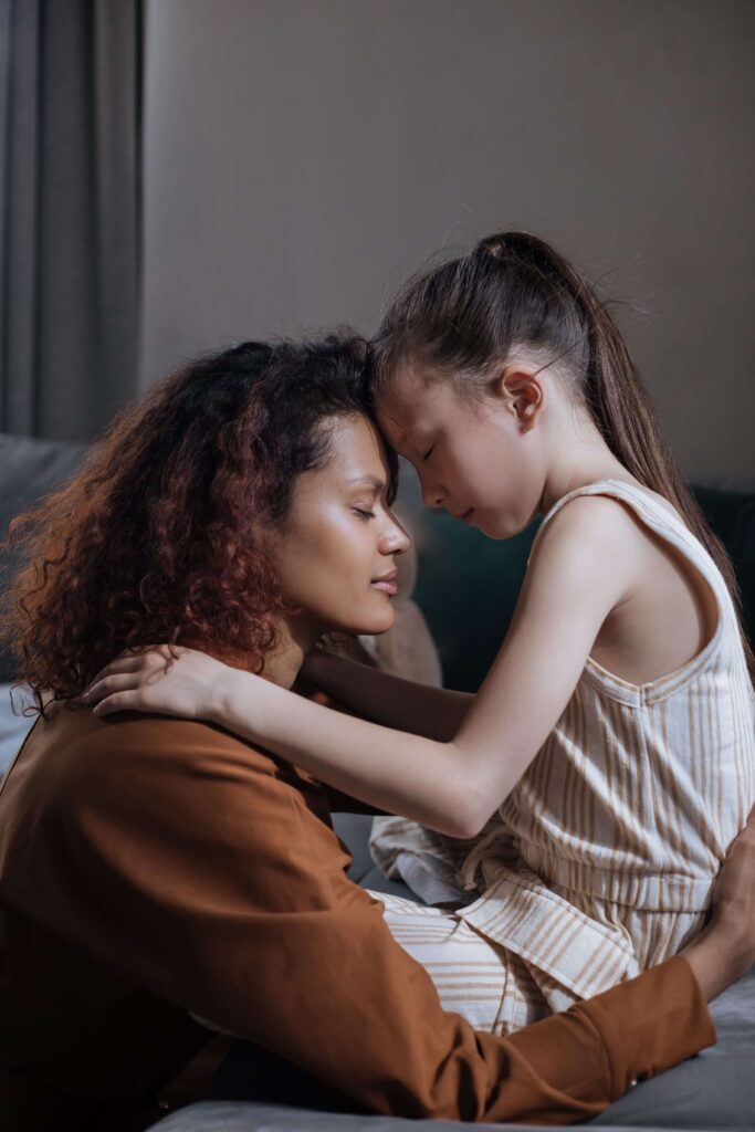 Woman’s daughter | burnout in relationship palm beach | complex ptsd online therapist palm beach, fl | relational trauma therapy | Palm Beach, Florida | Wellington | Boynton Beach | The Island | The Colony Hotel A mother and daughter share a tender moment with their foreheads touching. What does emotional labor look like in the quiet moments of parenting? Relational trauma therapy in Palm Beach, FL can help women feel supported, not just needed.