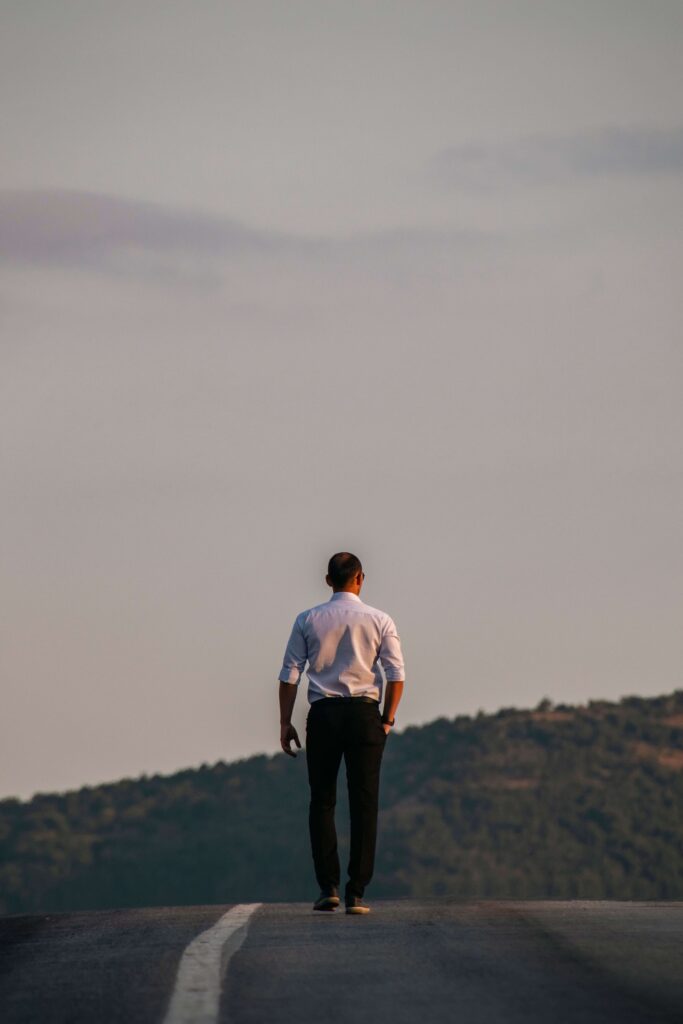 Walking alone | emotional effort in relationships palm beach | relational trauma therapist palm beach, fl | complex ptsd therapist | Palm Beach, Florida | Delray Beach | Westlake | The Palm Beaches | The Breakers A man walks alone down an empty road as hills stretch out behind him. What happens when a partner avoids hard conversations instead of facing them? Relational trauma therapy in Palm Beach, FL can help break this pattern of avoidance.
