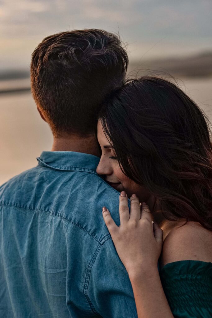 A couple embraces on a beach at sunset. Does disorganized attachment leave you craving closeness one moment and pulling away the next? Online relational trauma therapy in Palm Beach, FL can help you understand this pattern.