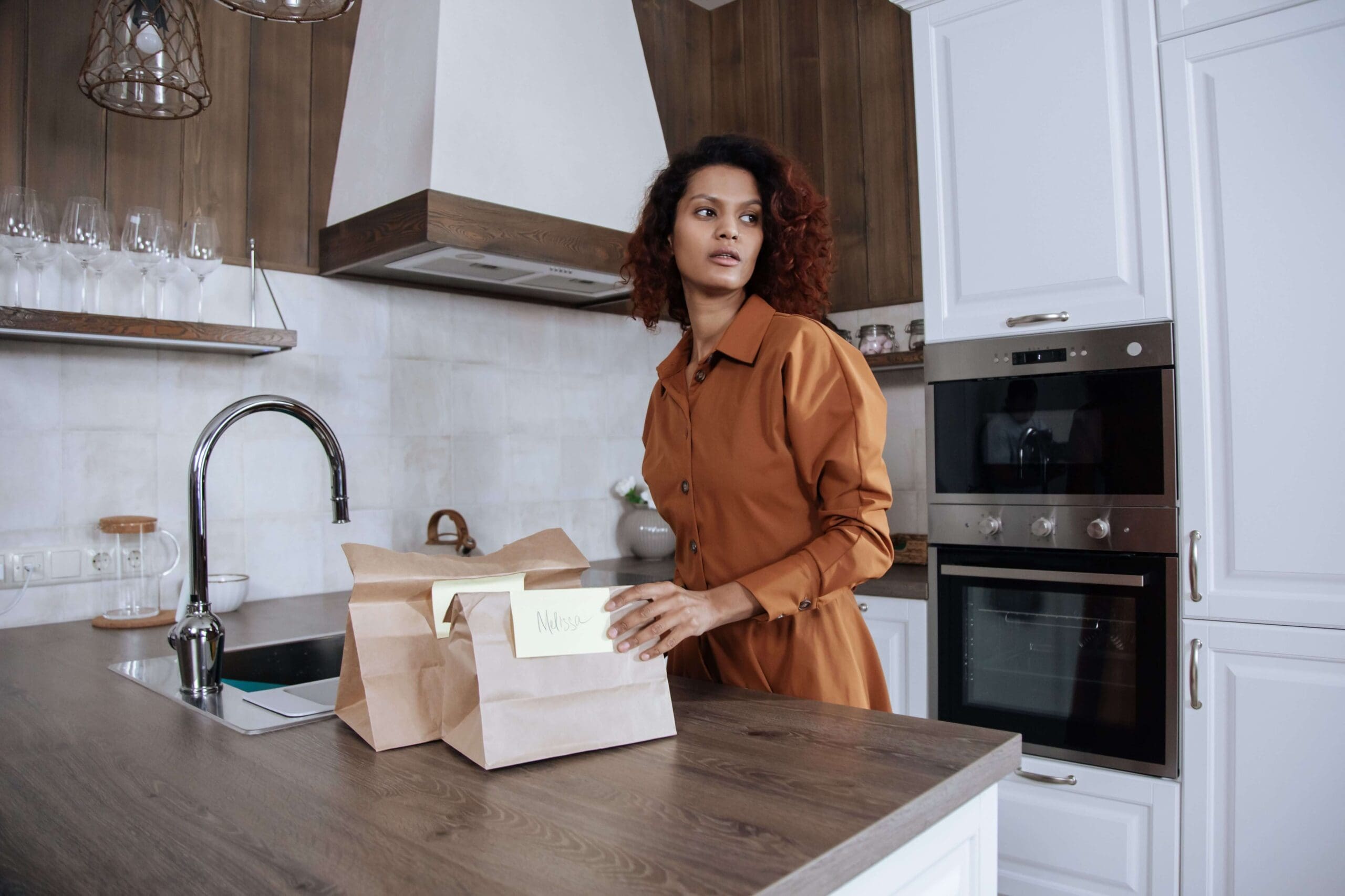 A mother stands in her kitchen preparing labeled lunch bags for her children before school. Is burnout already setting in as you juggle morning routines and endless to-do lists? An online relational trauma therapist in Palm Beach, FL offers support for overwhelmed moms.