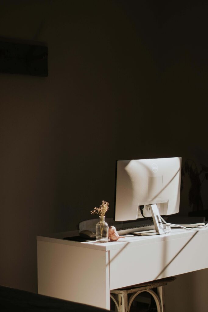 Computer | imposter syndrome palm beach, fl | trauma therapy for high achievers palm beach | online relational trauma therapy | Palm Beach, Florida | Jupiter | Palm Beach Gardens | Wall Street South | Whitehall A computer monitor and a small vase of dried flowers sit on a desk. Can achievement at work still leave you feeling like a fraud? An online relational trauma therapist in Palm Beach, FL can help you work through the disconnect between success and self-worth.
